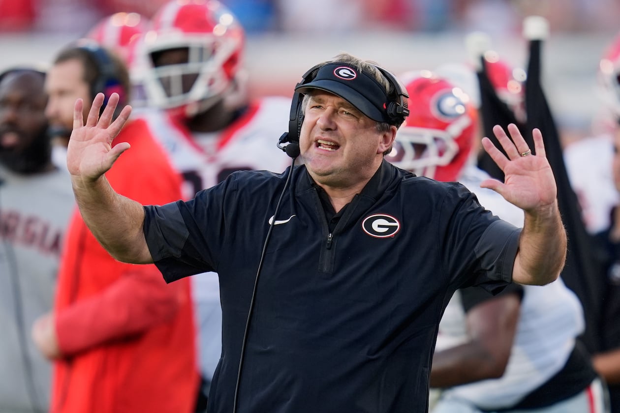 Georgia and coach Kirby Smart — pictured motioning to players on the field against Florida on Nov. 1 — may miss out on playing in the SEC championship game but still earn a first-round bye in the College Football Playoff. (John Raoux/AP)