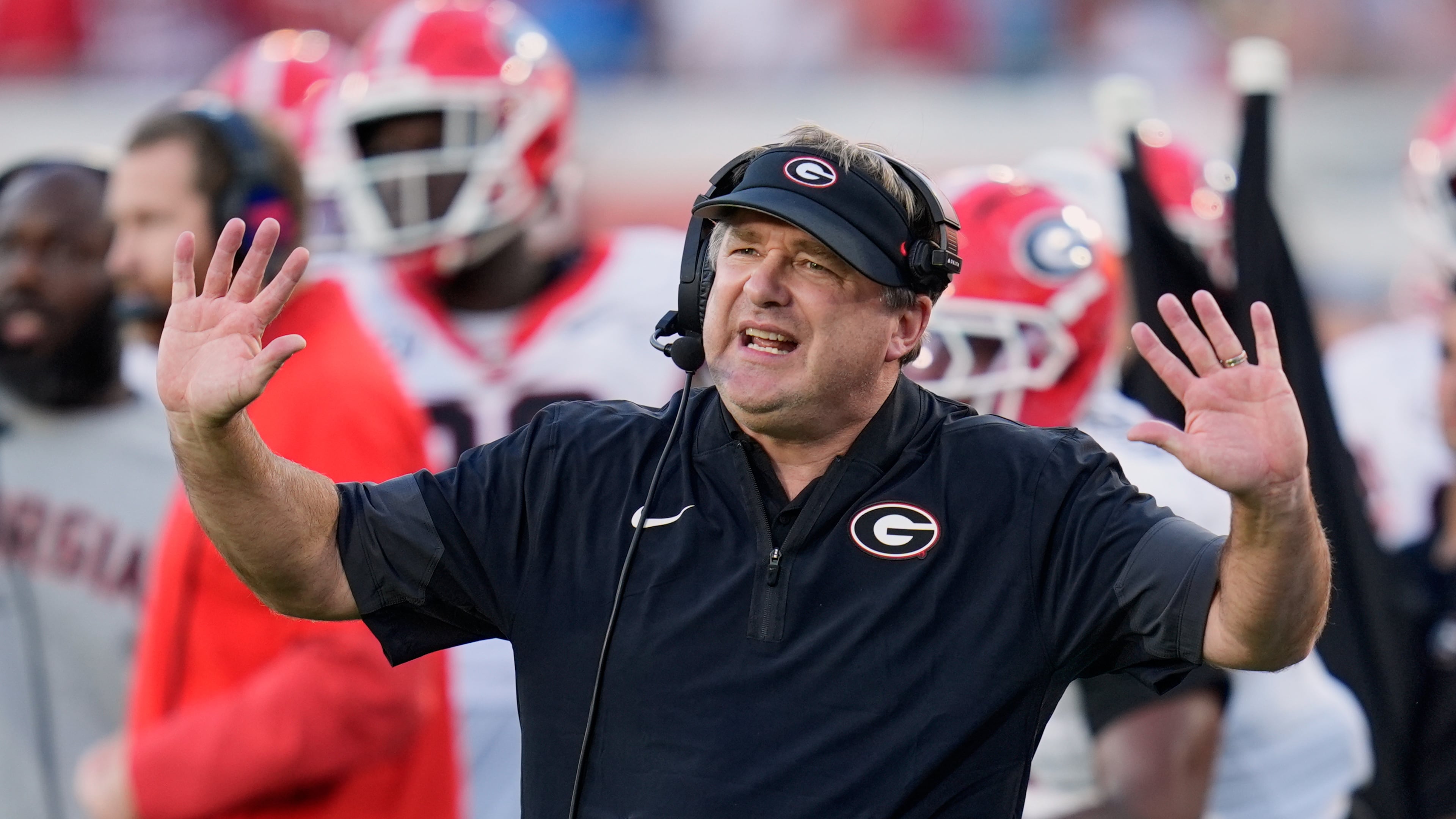 Georgia and coach Kirby Smart — pictured motioning to players on the field against Florida on Nov. 1 — may miss out on playing in the SEC championship game but still earn a first-round bye in the College Football Playoff. (John Raoux/AP)