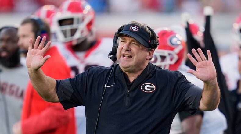 Georgia and coach Kirby Smart — pictured motioning to players on the field against Florida on Nov. 1 — may miss out on playing in the SEC championship game but still earn a first-round bye in the College Football Playoff. (John Raoux/AP)