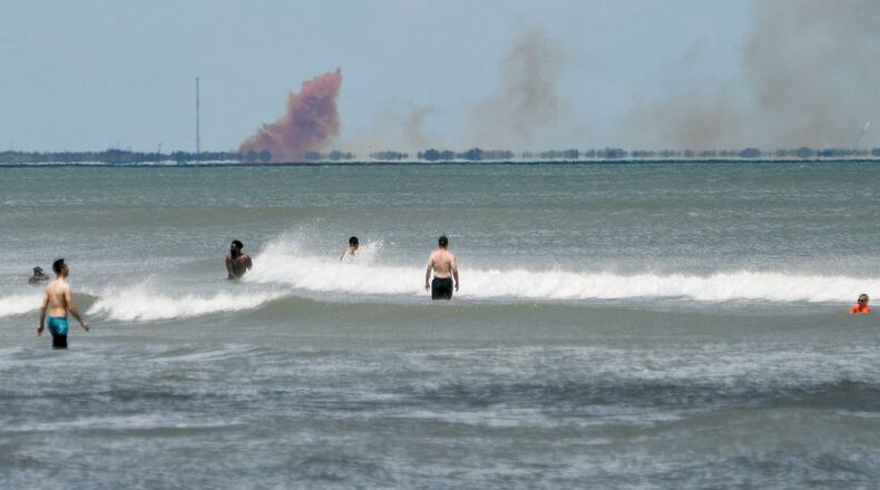 A cloud of orange smoke rises over nearby Cape Canaveral Air Force Station as seen from Cocoa Beach, Fla., Saturday, April 20, 2019. SpaceX reported an anomaly during test firing of their Dragon 2 capsule at their LZ-1 landing site. (Craig Bailey/Florida Today via AP)