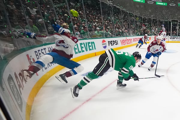 Colorado Avalanche defenseman Erik Johnson, left, and Dallas Stars right wing Mikko Rantanen (96) collide while competing for the puck during the first period in Game 2 of a first-round NHL hockey playoff series Monday, April 21, 2025, in Dallas. (AP Photo/Julio Cortez)