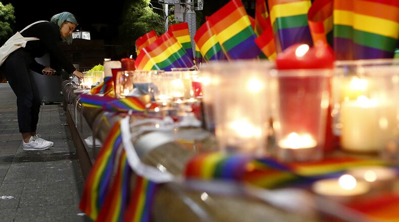 SYDNEY, AUSTRALIA - JUNE 13:  A woman lights a candle during a candlelight vigil for the victims of the Pulse Nightclub shooting in Orlando, Florida, at Oxford St on June 13, 2016 in Sydney, Australia. 50 people were killed and 53 injured after a gunman opened fire on people in a gay nightclub in Florida. It is the deadliest mass shooting in US history.  (Photo by Daniel Munoz/Getty Images)