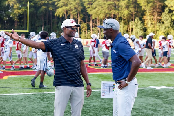 UGA great Champ Bailey (left), a coach for Holy Innocents', speaks with Mount Vernon head coach Terrence Edwards (right), a former UGA standout, after the Mount Vernon vs. Holy Innocents' high school football game at Holy Innocents' Episcopal School in Atlanta on Sept. 4, 2026. Holy Innocents won 51-14. (Arvin Temkar/AJC)