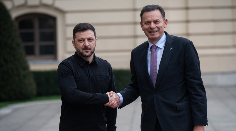 Ukraine's President Volodymyr Zelenskyy, left, shakes hands with Portuguese Prime Minister Luís Montenegro in Kyiv, Ukraine, Saturday, Dec. 20, 2025. (AP Photo/Danylo Antoniuk)