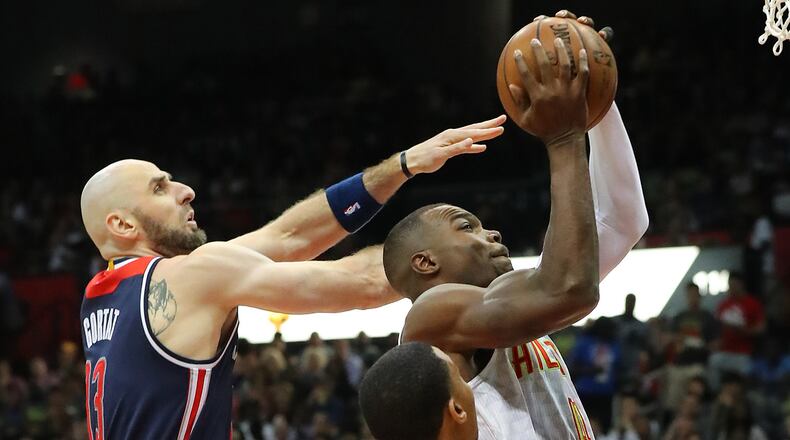 Atlanta Hawks’ Paul Millsap draws a foul from Washington Wizards’ Marcin Gortat on his way to the basket in Game 3 of a first-round NBA basketball playoff series on Saturday, April 22, 2017, in Atlanta. Curtis Compton/ccompton@ajc.com