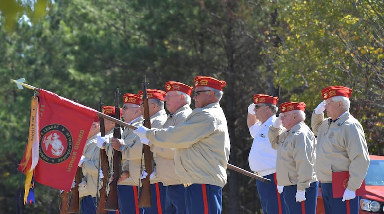 John Newport, second from right, salutes with other members of the Marine Corps League Woodstock detachment’s Ceremonial Rifle Team at Georgia National Cemetery in Canton on Friday, November 1, 2019. (Hyosub Shin / Hyosub.Shin@ajc.com)