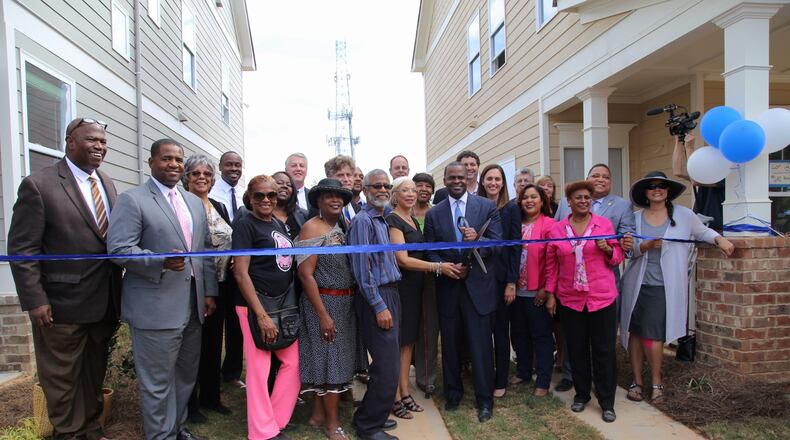 Atlanta Mayor Kasim Reed joins city and community officials Wednesday during a ribbon cutting ceremony celebrating new affordable housing for residents in Mechanicsville.