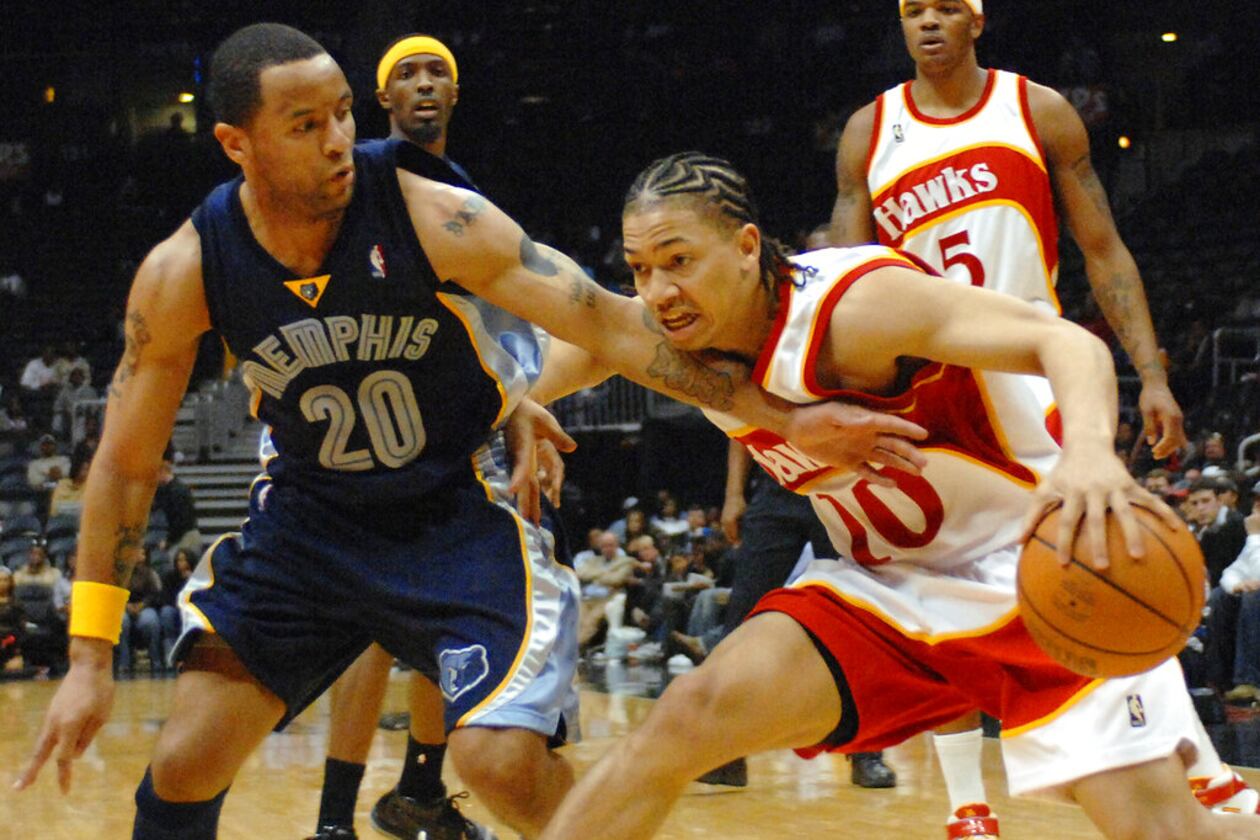 Hawks guard Tyronn Lue (right) drives against Grizzlies guard Damon Stoudamire during the third quarter Friday, March 9, 2007, in Atlanta. (Gregory Smith/AP)