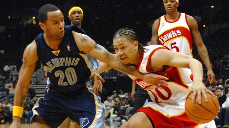 Hawks guard Tyronn Lue (right) drives against Grizzlies guard Damon Stoudamire during the third quarter Friday, March 9, 2007, in Atlanta. (Gregory Smith/AP)