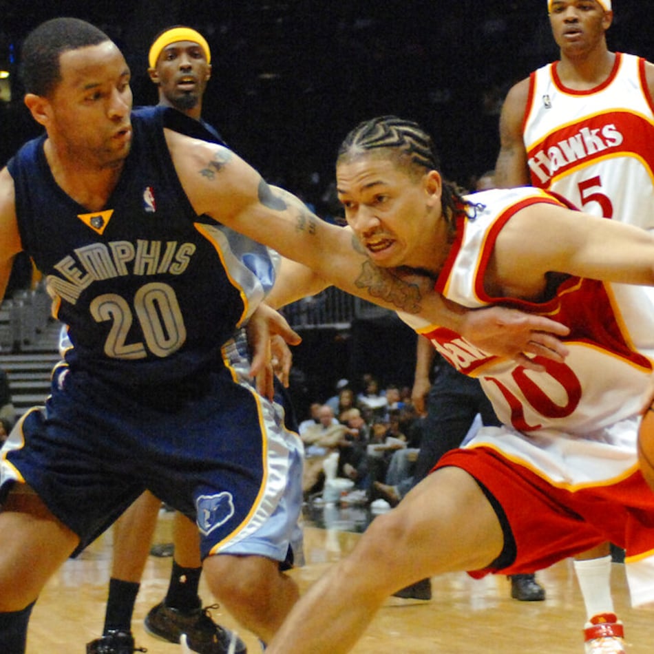 Hawks guard Tyronn Lue (right) drives against Grizzlies guard Damon Stoudamire during the third quarter Friday, March 9, 2007, in Atlanta. (Gregory Smith/AP)