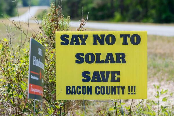A sign near the construction site of one of the state’s largest solar farms in Bacon County voices opposition to the project. (Miguel Martinez/AJC)