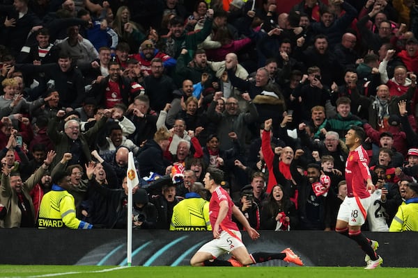 Manchester United's Harry Maguire, left, celebrates with team mates after his side's fifth goal during the Europa League quarter final second leg soccer match between Manchester United and Olympique Lyon in Manchester, Britain, Thursday, April 17, 2025. (AP Photo/Jon Super)