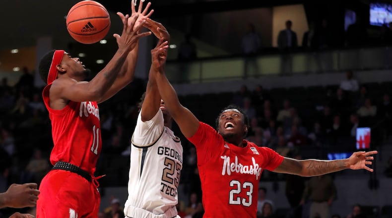 Nebraska guards Dachon Burke Jr. (11) and Jervay Green (23) battle Georgia Tech guard Shembari Phillips (2) for a rebound in the first half of an NCAA college basketball game Wednesday, Dec. 4, 2019, in Atlanta. (AP Photo/John Bazemore)
