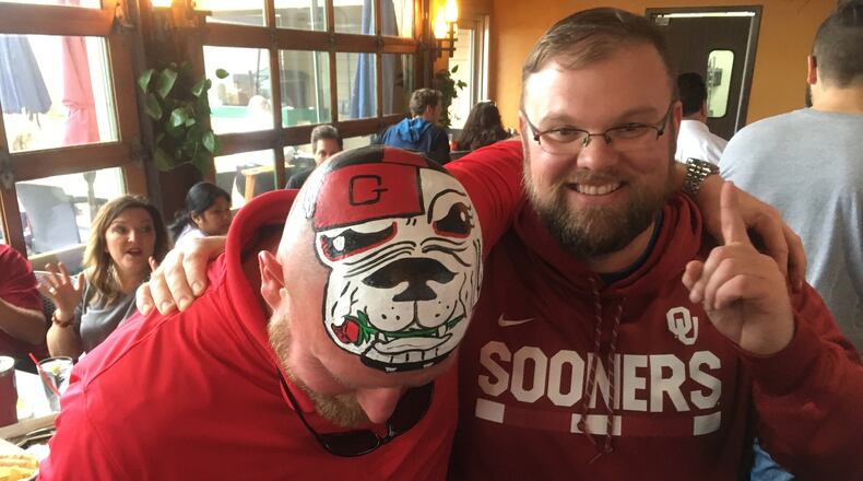 Robert King is an Oklahoma fan but wanted a photo with UGA superfan Trent "Big Dawg III" Woods. Photo: Jennifer Brett