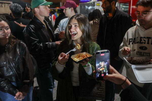 Farah Alkarwe tastes a Biscoff Explosion pancake from ATL Minipancakes at the Atlanta Ramadan Food Festival in Norcross on Friday, Feb. 27, 2026. (Arvin Temkar/AJC)