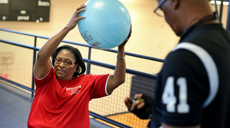 Karen Wright, left, does low impact exercises under the supervision of personal trainer Harry Wright (no relation) at Virginia Burton Gay Recreation Center recently in Riverdale. Karen Wright has heart disease and now uses a left ventricle assist device or heartmate to help pump her blood. Wright works out to lose weight and stay in shape in hopes of getting a heart transplant. She is on the heart transplant list.