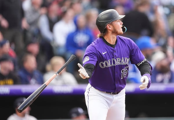Colorado Rockies' Hunter Goodman tosses his bat as he heads up the first base line after hitting a three-run home run off Atlanta Braves starting pitcher Bryce Elder in the first inning of a baseball game Monday, April 28, 2025, in Denver. (AP Photo/David Zalubowski)