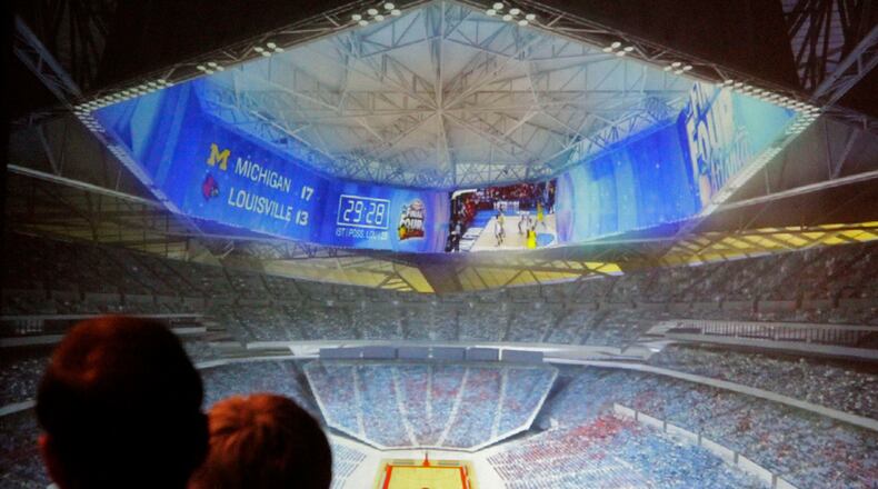 Members of the Georgia World Congress Center Authority board view a rendering of a prototype stadium design that includes a 360-degree video screen. The board approved a contract Tuesday with Kansas City-based 360 Architecture to design the new Falcons stadium.