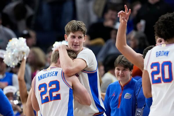Florida guard Bennett Andersen (22) hugs forward Alex Condon after they won the Sweet 16 of the NCAA college basketball tournament game against Maryland, Thursday, March 27, 2025, in San Francisco. (AP Photo/Godofredo A. Vásquez)