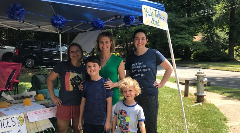 Sen. Elena Parent (center) tweeted about her visit to a lemonade stand in DeKalb County, where the proceeds will be donated to support children in ICE custody.