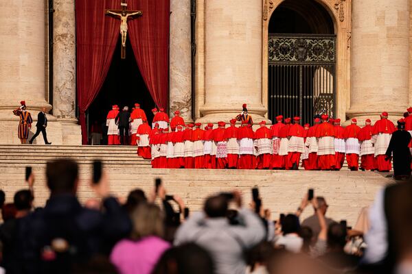 Cardinals walk through St. Peter's Square ahead of the coffin of Pope Francis, who will lie in state at St. Peter's Basilica for three days, at the Vatican, Wednesday, April 23, 2025. (AP Photo/Andreea Alexandru)