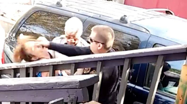 Flagstaff officer captured on video punching woman.