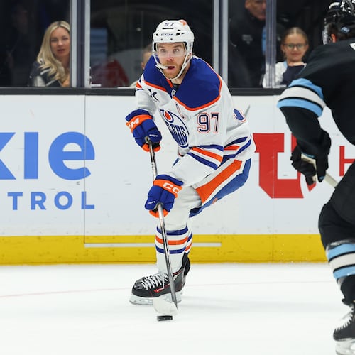 Edmonton Oilers center Connor McDavid (97) controls the puck against Utah Mammoth center Nick Schmaltz (8) during the first period of an NHL hockey game, Tuesday, March 24, 2026, in Salt Lake City. (AP Photo/Melissa Majchrzak)