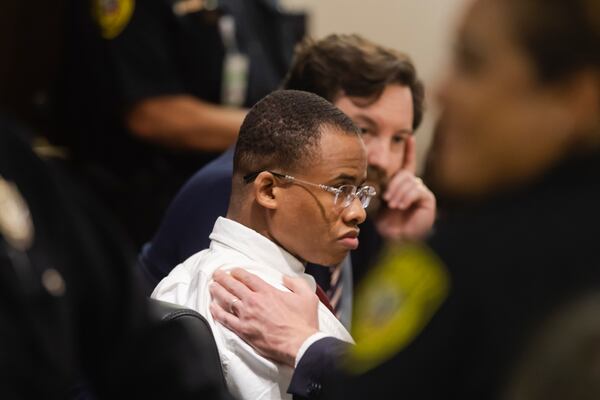 Defendant Taymor McIntyre is assured by defense attorney John Hunter before the jury's verdict is read aloud during his trial in San Antonio, on Monday, April 14, 2025. (Josie Norris/The San Antonio Express-News via AP)