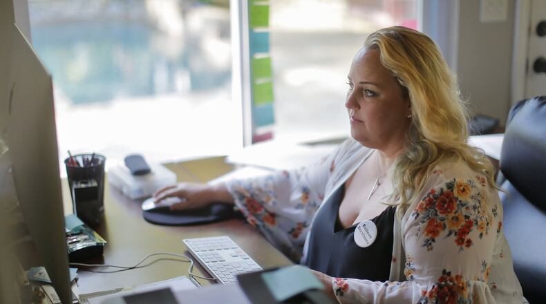 Tamara Stevens, 48, works as an organizer for “No Safe Seats” at her Roswell home. After traveling to Washington, D.C., with a group of women from metro Atlanta, Stevens returned home to have a tough conversation with her sons about sexual assault. BOB ANDRES / BANDRES@AJC.COM
