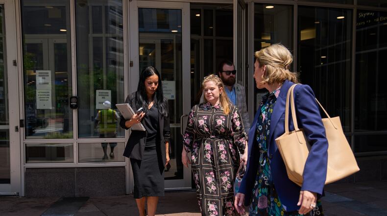 Colin Hortman, behind, son of Melissa and Mark Hortman, and his wife Alina Bachman Hortman, second from left, leave after attending the initial state court appearance for Vance Boelter, Monday, Aug. 3, 2026, in Minneapolis. (AP Photo/Ellen Schmidt)