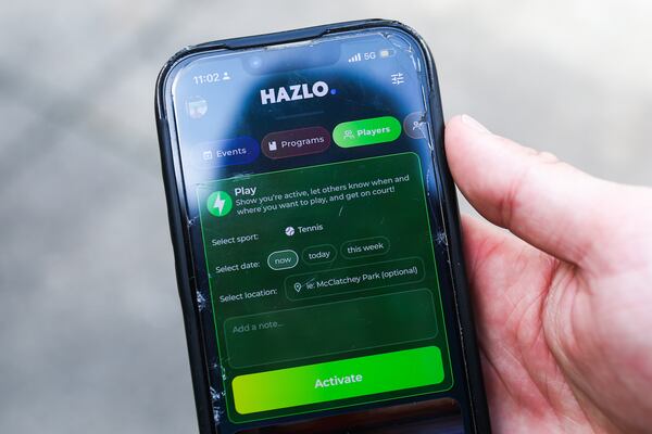 Juan Segundo Caratini, co-founder of Hazlo, looks at the app on his phone. After creating a profile, members are able to follow your page, view your skill level and see when you’re available to play. (Abbey Cutrer/AJC)