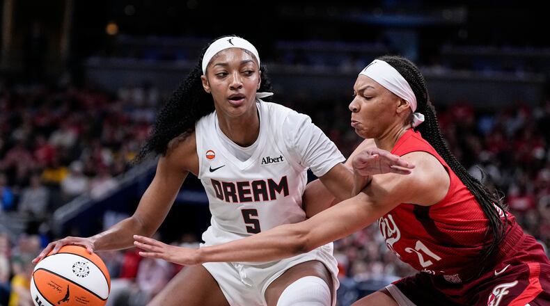 Indiana Fever forward Makayla Timpson (21) defends Atlanta Dream forward Angel Reese (5) in the second half of a WNBA basketball game in Indianapolis, Thursday, June 18, 2026. (AP Photo/Michael Conroy)