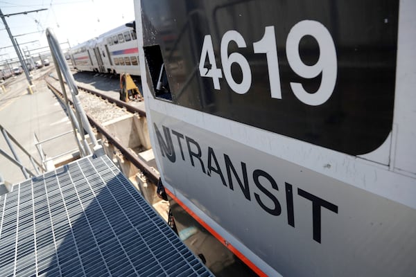 FILE - A train is seen on a maintenance track at New Jersey Transit's Meadows Maintenance Complex, Tuesday, May 1, 2018, in Kearny, N.J. (AP Photo/Julio Cortez, File)