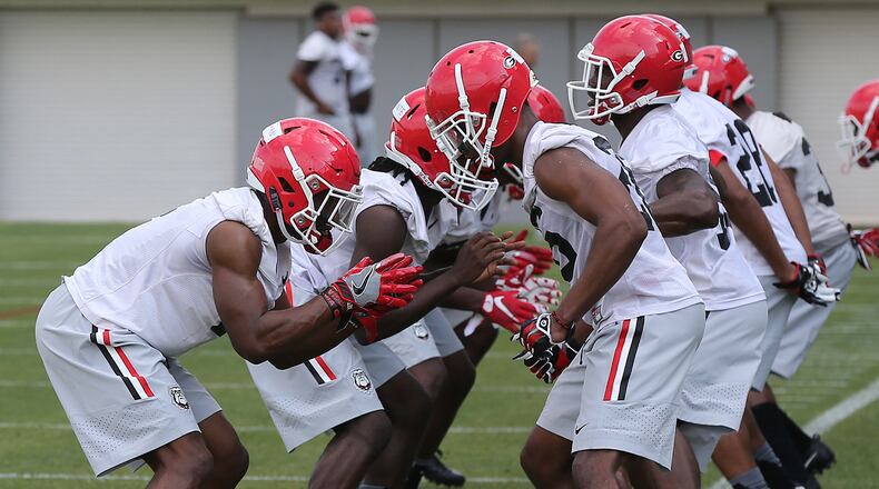 Georgia defensive players run through drills on the first day of spring football practice Tuesday, March 21, 2017, in Athens.