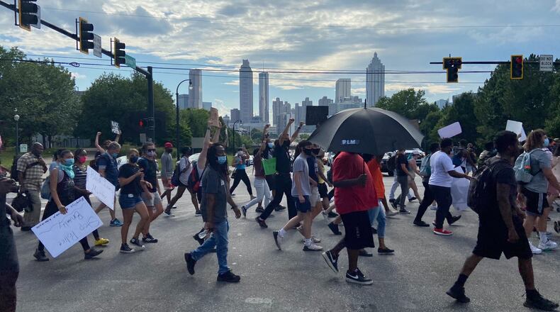 A group of peaceful demonstrators march down Boulevard on Thursday afternoon in Atlanta’s Old Fourth Ward neighborhood.