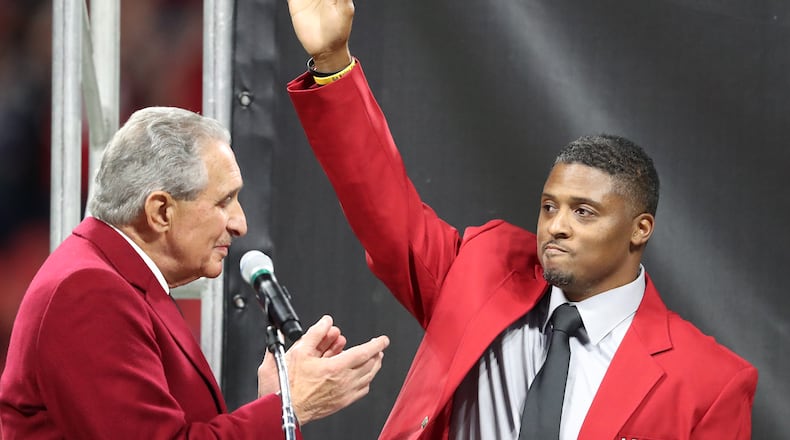 Team owner Arthur Blank applaudes former Falcons running back Warrick Dunn as he is inducted into the Ring of Honor during half time against the Saints in a NFL football game on Thursday, December 7, 2017, in Atlanta. Curtis Compton/ccompton@ajc.com