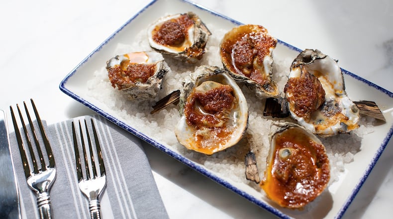 Roast barbecue oysters served with bourbon smoked jalapeño butter at The Emporium Kitchen & Wine Market. Contributed by The Emporium