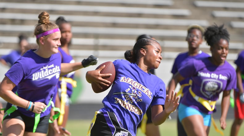 Gwinnett girls flag football players practice at Duluth High School on Oct. 3. This week, Atlanta Public Schools announced it would add flag football as a middle school girls’ sport beginning next year. HYOSUB SHIN / HSHIN@AJC.COM