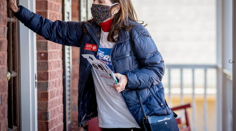 Claudia Eisenburg knocks on the door of a Peachtree City house while canvassing the neighborhood on Dec. 14, 2020. (Steve Schaefer for The Atlanta Journal-Constitution)