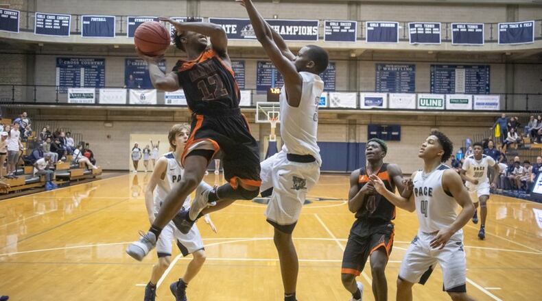 Hart County High School basketball player Elijah Robison tries to take a shot while being guarded by Pace Academy High School player Madison, Durr during the first round of the state basketball tournament at Pace Academy high school Saturday, February 16, 2019. STEVE SCHAEFER / SPECIAL TO THE AJC