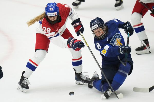 Finland's Elli Suoranta, right, challenges Noemi Neubauerova of Czech Republic during the bronze medal match between Czech Republic and Finland at the Women's Ice Hockey Championships in Ceske Budejovice, Czech Republic, Sunday, April 20, 2025. (AP Photo/Petr David Josek)