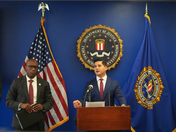 U.S. Attorney Bill Essayli, at podium with Akil Davis is the Assistant Director in Charge of the FBI's Los Angeles Field Office, left, answer questions during a news conference in Los Angeles, Wednesday, June 4, 2025. (AP Photo/Damian Dovarganes)