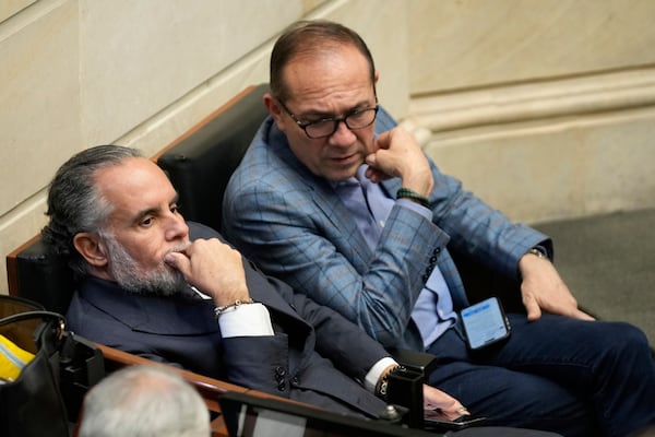 Colombian Interior Minister Armando Benedetti, left, and Labor Minister Antonio Sanguino gesture during a discussion on a referendum proposal on labor reform, in Bogota, Colombia, Wednesday, May 14, 2025. (AP Photo/Fernando Vergara)