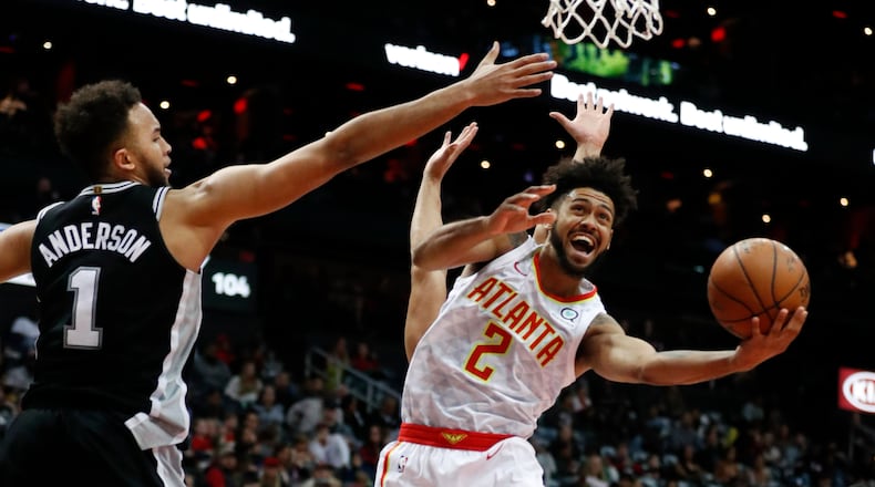 Atlanta Hawks guard Tyler Dorsey (2) goes up for as shot as San Antonio Spurs forward Kyle Anderson (1) defends in the second half of an NBA basketball game Monday, Jan. 15, 2018, in Atlanta. The Hawks won 102-99. (AP Photo/John Bazemore)