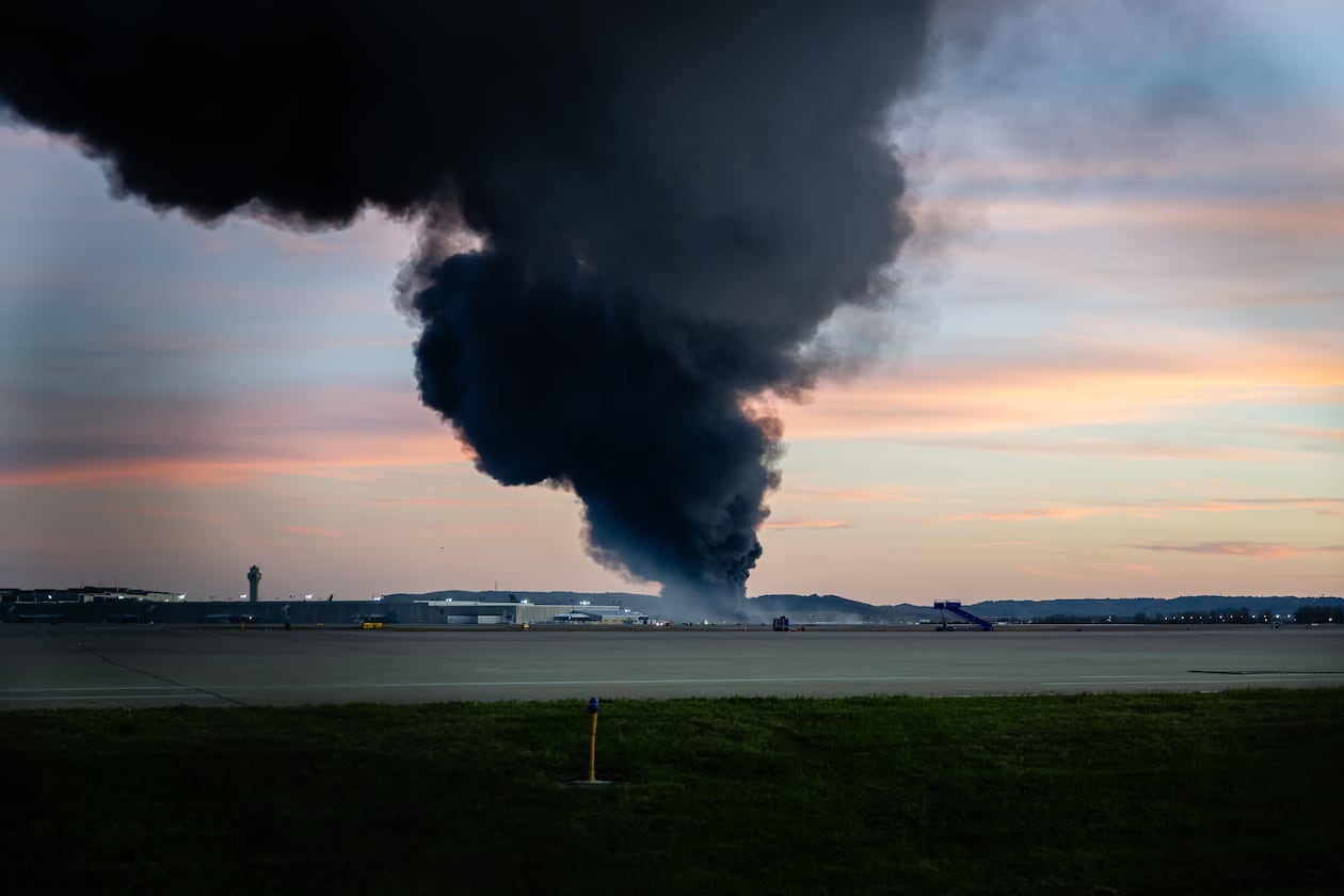 A plume of smoke rises from the site of a UPS cargo plane crash at Louisville Muhammad Ali International Airport on Tuesday, Nov. 4, 2025, in Louisville, Ky. (Jon Cherry/AP)