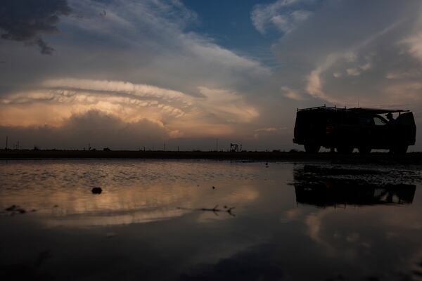 Northern Illinois University's Husky Hail Hunter is silhouetted near Lubbock, Texas, Friday, June 6, 2025, during a Project ICECHIP operation. (AP Photo/Carolyn Kaster)