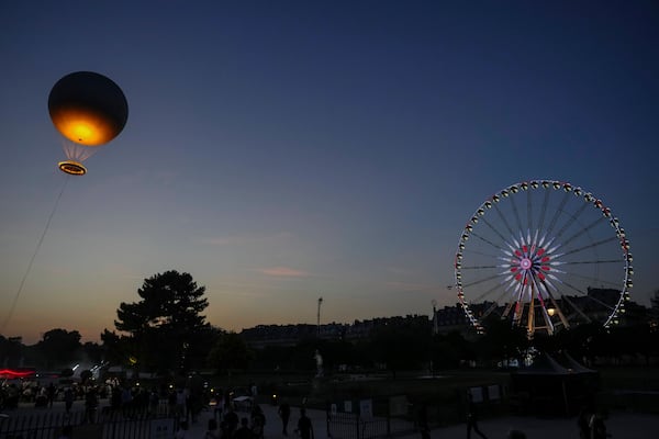 The helium ballon that was used during the 2024 Olympic Games as the Olympic cauldron is launched in the Tuileries Gardens of Paris on Saturday, June 21, 2025. (AP Photo/Aurelien Morissard)