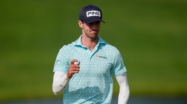 Alex Smalley waves on the 10th green during the third round of the PGA Championship golf tournament at Aronimink Golf Club, Saturday, May 16, 2026, in Newtown Square, PA. (AP Photo/Matt Slocum)