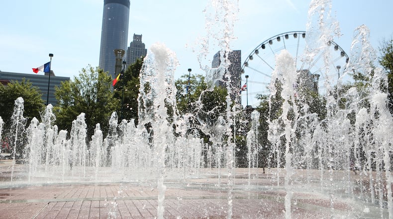 July 20, 2016 Atlanta: The Fountain of Rings plash in front of Atlanta skyscrapers and the SkyView ferris wheel in Centennial Olympic Park on Wednesday, July 20, 2016. This year Atlanta is celebrating the 20th anniversary of the 1996 Olympic Games. EMILY JENKINS/ EJENKINS@AJC.COM