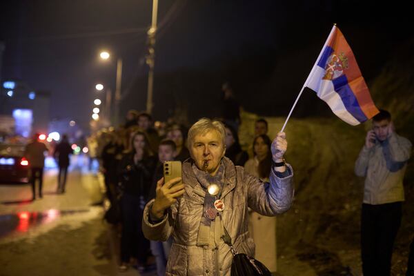 A woman welcomes a group of students who walked across the country arrive at an anti-corruption protest in the southwestern town of Novi Pazar, Serbia, Friday, April 11, 2025. (AP Photo/Marko Drobnjakovic)